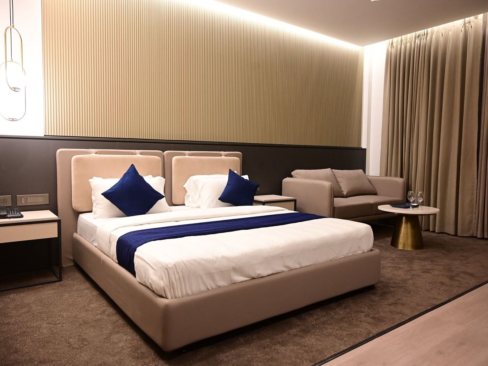 image of the bedroom at club charholi, pune featuring a double bed in the middle of the room